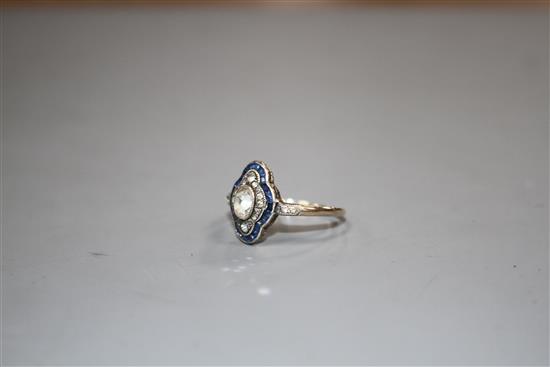 A mid 20th century yellow metal (stamped 9ct?, blue and white paste set quatrefoil shaped ring, size P, gross 2.6 grams.